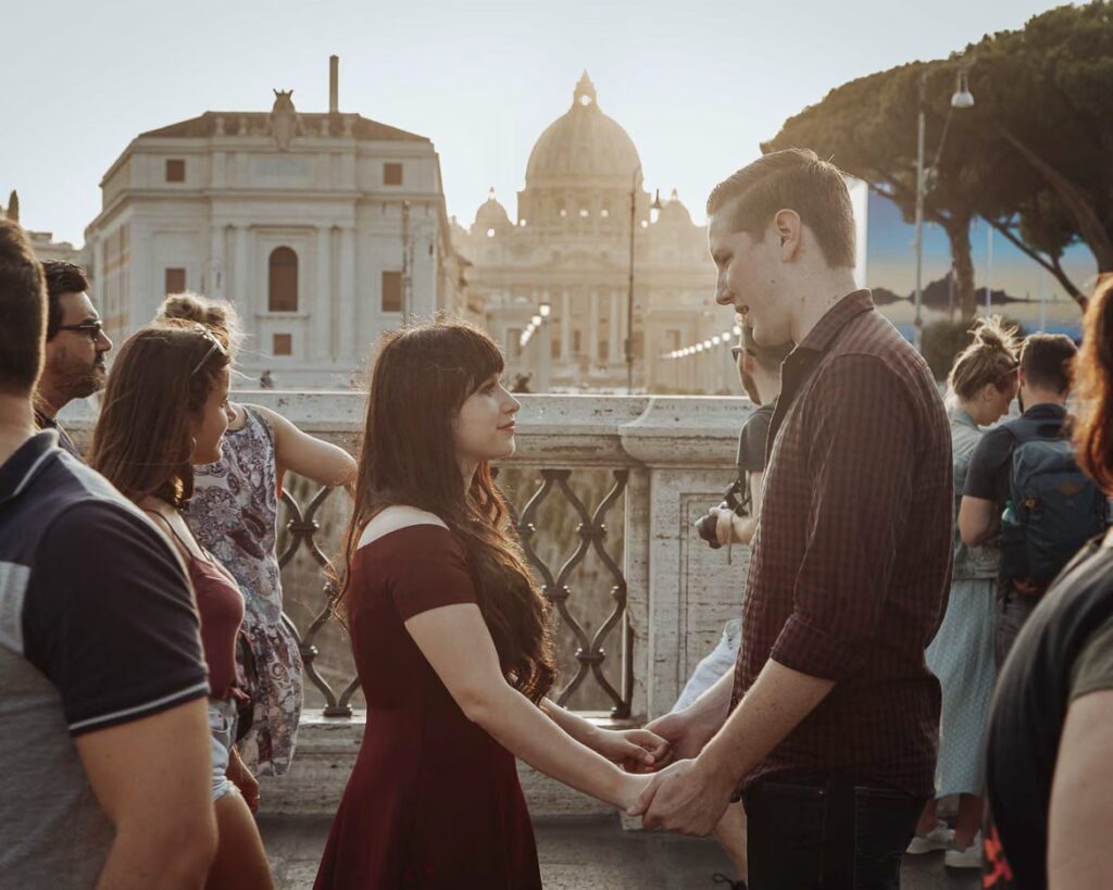 in love couple with St.Peter Basilic in the background during a Rome engagemnt photoshoot