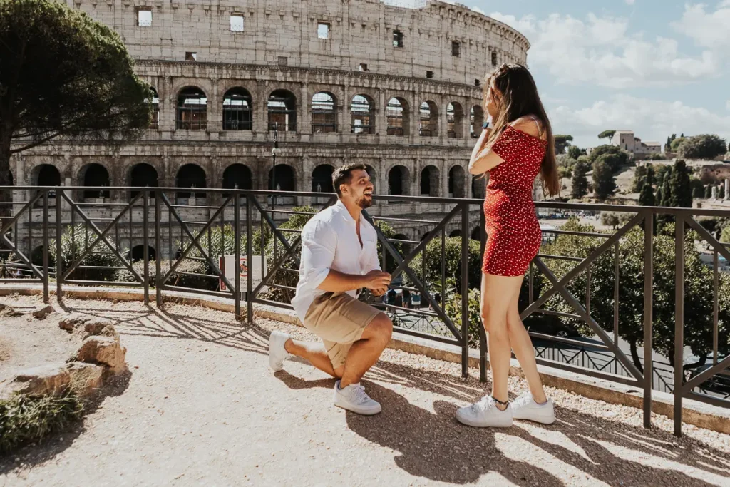 a young man on his knees is proposing his girlfriend after Rome proposal planning with Alina